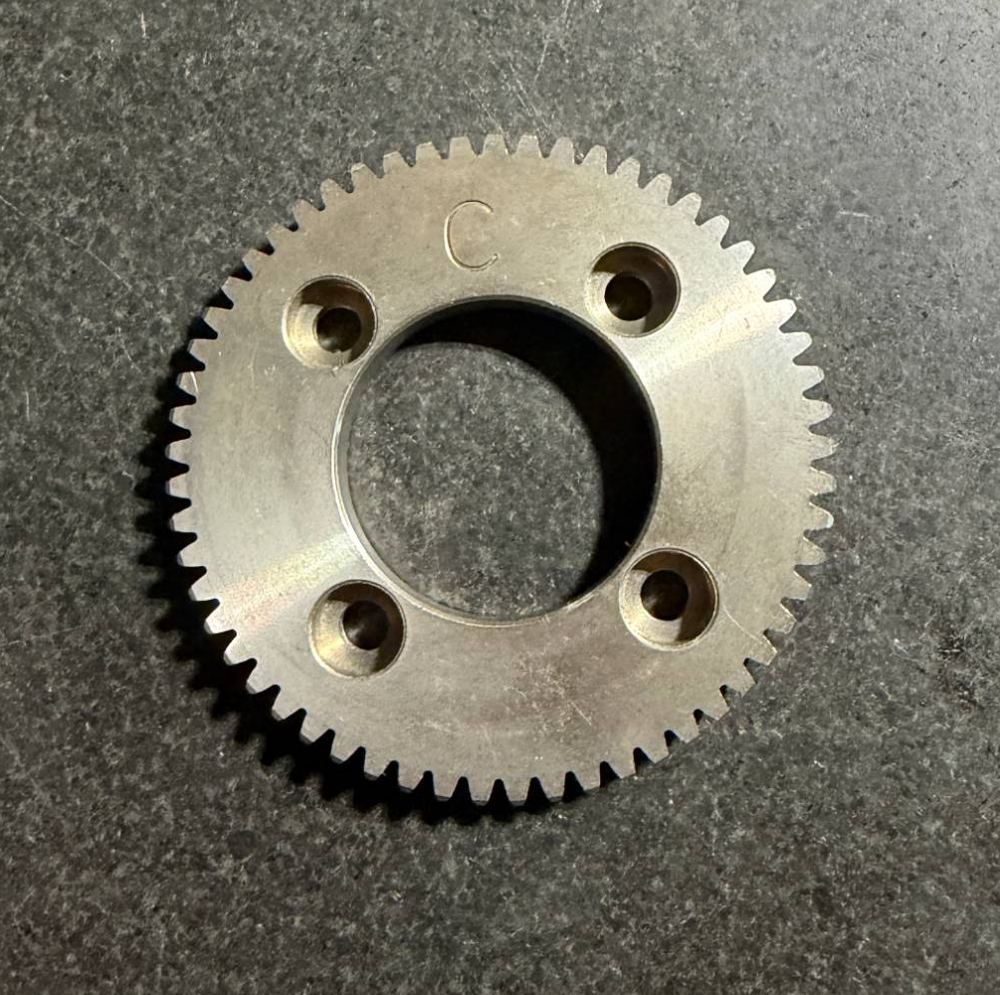 Small precision spur gear with four counterbored bolt holes